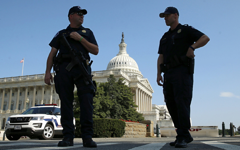 U.S. Capitol Police officers stand outside the Capitol July 8 in Washington. (CNS/Kevin Lamarque, Reuters)