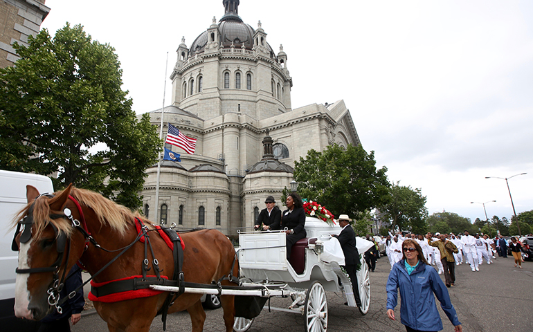 A horse-drawn carriage carries the casket of Philando Castile July 14 as it passes the Cathedral of St. Paul in St. Paul, Minn. (CNS/Dave Hrbacek, The Catholic Spirit)