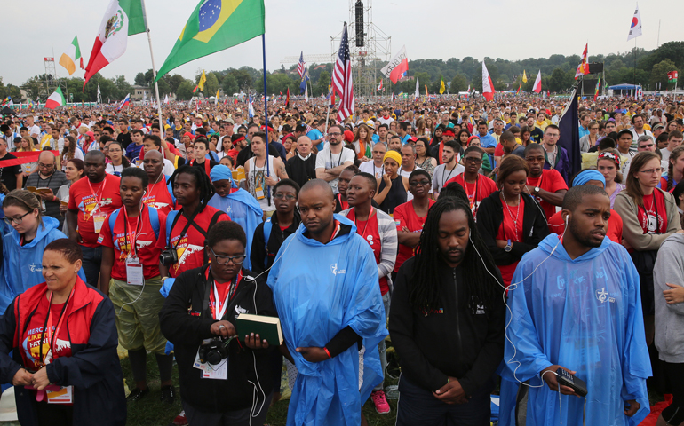 Pilgrims attend the opening Mass for World Youth Day July 26 at Blonia Park in Krakow, Poland. (CNS/Bob Roller)