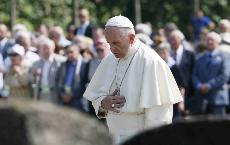 Pope Francis prays at a memorial to victims at the Birkenau Nazi death camp in Oswiecim, Poland, July 29. (CNS photo/Paul Haring) 