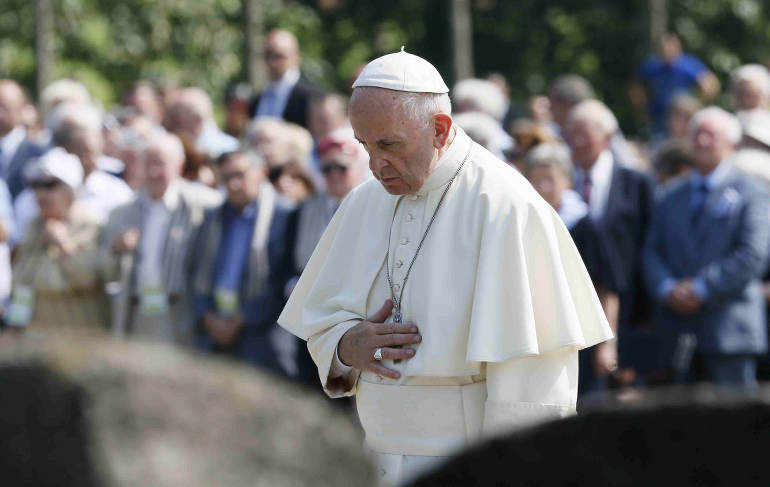 Pope Francis prays at a memorial to victims at the Birkenau Nazi death camp in Oswiecim, Poland, July 29. (CNS photo/Paul Haring)