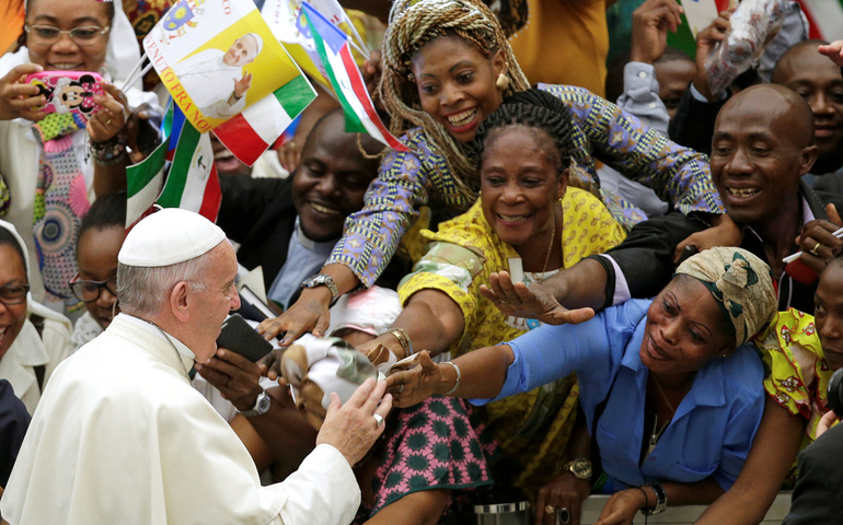 Pope Francis greets the faithful as he arrives to lead his general audience in Paul VI hall at the Vatican Aug. 10. (CNS photo/Max Rossi, Reuters)