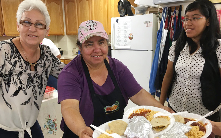 Carmen Alvear and other parishioners from San Felipe de Jesus Parish in Brownsville, Texas, prepare a special meal for unaccompanied children from Central America who attend Mass at their church. (CNS/Rose Ybarra, The Valley Catholic)