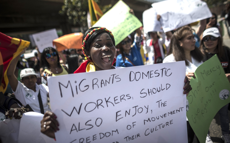 Women protest for better wages and working conditions for migrant domestic workers in Beirut May 1. Pope Francis prayed for all exploited women and girls during the feast of the Assumption at the Vatican Aug. 15. (CNS/Oliver Weiken, EPA)