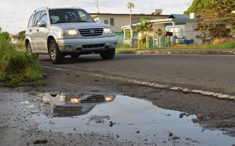 A street puddle is seen in San German, Puerto Rico, in this undated photo. Puddles of water contribute to the spread of Zika in Puerto Rico. (CNS photo/CNS photo/Wallice J. de la Vega)