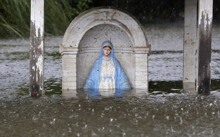 A statue of Mary is seen partially submerged in flood water in Sorrento, La., Aug. 20. (CNS photo/Jonathan Bachman, Reuters)