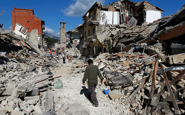 A man walks amid rubble following an earthquake in Amatrice, Italy, Aug. 24. (CNS/Remo Casilli, Reuters)