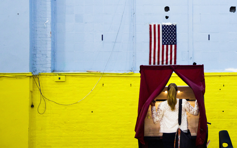 A woman enters a voting booth in Hoboken, N.J., June 7. (CNS/Justin Lane, EPA)
