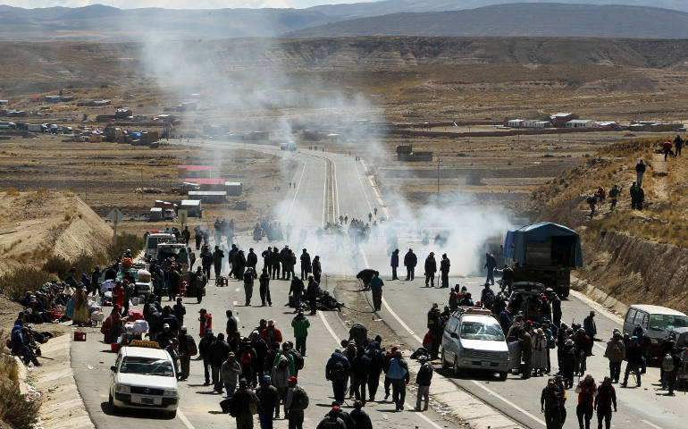 Bolivian miners clash with police Aug. 11 during a protest along a road in Mantecani. (CNS photo/Martin Alipaz, EPA)