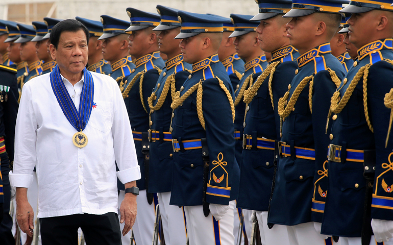 Philippine President Rodrigo Duterte reviews honor guards upon his arrival at the Villamor air base in Manila. (CNS/Romeo Ranoco, Reuters)