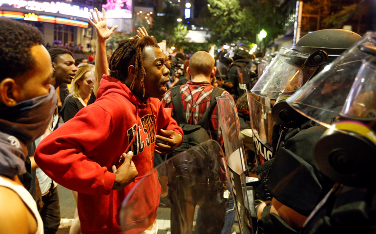 A man confronts riot police during Sept. 21 protests in Charlotte, N.C. (CNS/Jason Miczek, Reuters)