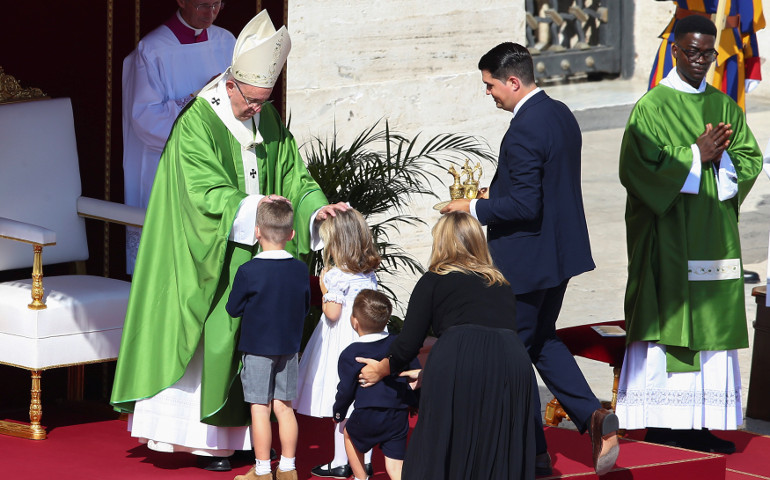 Pope Francis blesses a family as he celebrates a Mass for the Jubilee for Catechists Sept. 25, 2016, in St. Peter’s Square at the Vatican. (CNS/Reuters/Alessandro Bianchi)