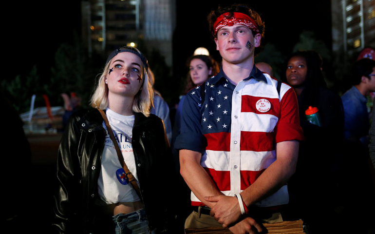 Young people watch the debate between Donald Trump and Hillary Clinton outside Hofstra University, Sept. 27 in Hempstead, N.Y. (CNS/Shannon Stapleton, Reuters)