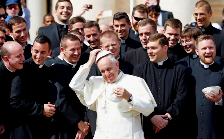 Pope Francis exchanges his skullcap as he poses with seminarians from the Pontifical North American College on Sept. 28, 2016, in St. Peter's Square at the Vatican. (CNS/Reuters/Remo Casilli)