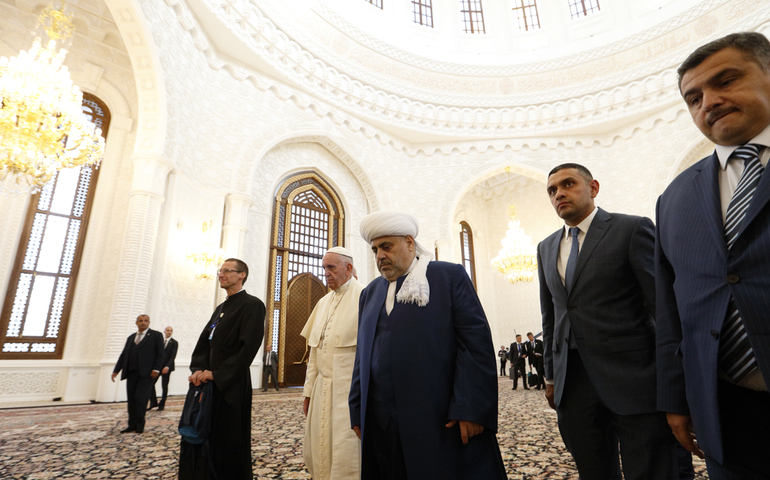 Pope Francis walks with Sheikh Allahshukur Pashazadeh during a meeting with representatives of other religious communities at the Heydar Aliyev Mosque in Baku, Azerbaijan, Oct. 2. (CNS photo/Paul Haring)