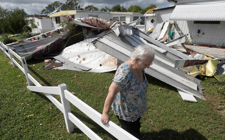 Cherie Monroe pauses after looking at the roof of her home Oct. 9 in the aftermath of Hurricane Matthew in Port Orange, Fla. (CNS/Phelan Ebenhack, Reuters)