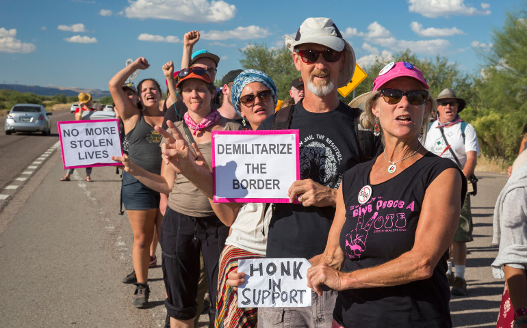 Immigration reform activists march through the Border Patrol checkpoint Oct. 9 in Tubac, Ariz., along the U.S.-Mexico border. (CNS/Jim West)