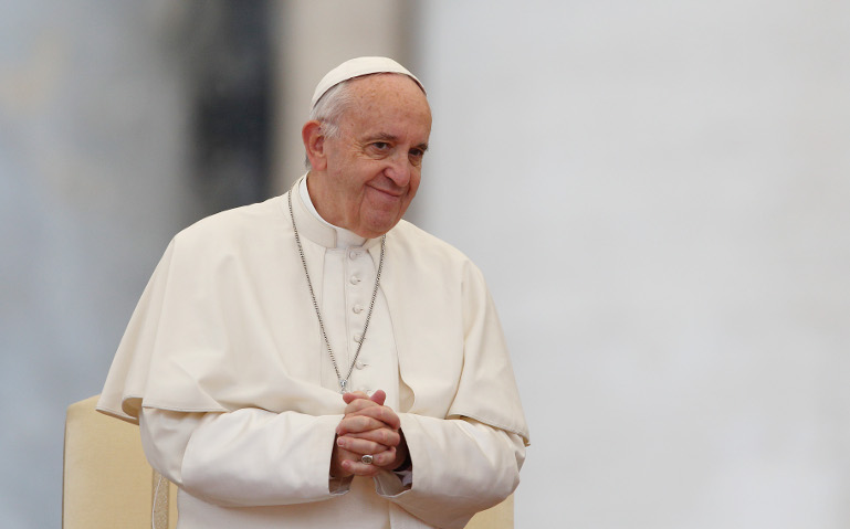 Pope Francis smiles as he leads his general audience in St. Peter's Square at the Vatican Oct. 26. (CNS/Paul Haring)