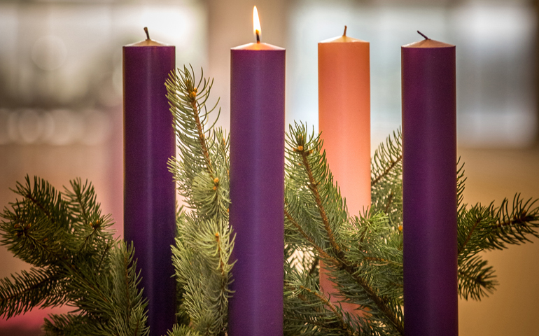 A lit candle is seen on an Advent wreath. Advent, a season of joyful expectation before Christmas, begins Nov. 27 this year. (CNS/Lisa Johnston, St Louis Review)