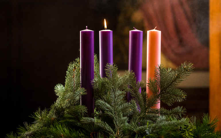A lit candle is seen on an Advent wreath. (CNS/Lisa Johnston, St Louis Review)