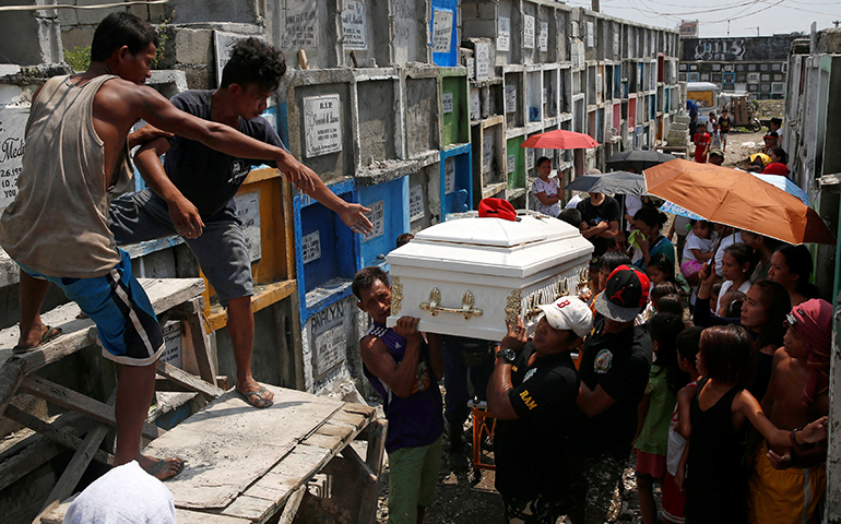 Men carry the coffin of Vicente Batiancila Oct. 23, who police say was among five victims of recent drug-related killings, during his funeral in Manila, Philippines. (CNS/Erik De Castro, Reuters)