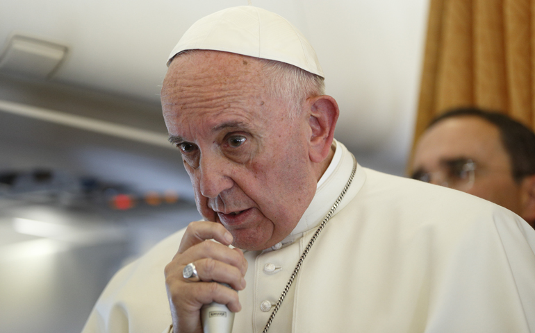 Pope Francis answers questions from journalists aboard his flight from Malmo, Sweden, to Rome Nov. 1. (CNS/Paul Haring)
