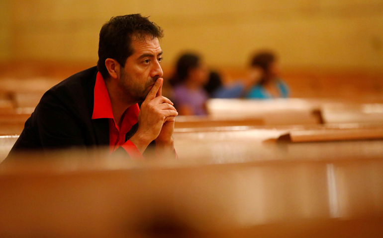 Ernesto Vega of the Los Angeles archdiocese Hispanic ministry, listens at an interfaith prayer service for the immigrant community Nov. 10 at the Cathedral of Our Lady of the Angels in Los Angeles. (CNS/Patrick T. Fallon, Reuters)