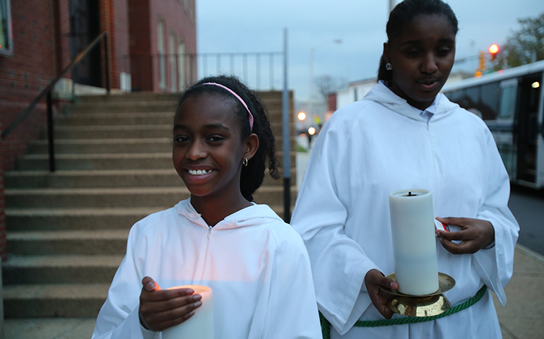 Altar servers stand outside St. Peter Claver Church in Baltimore before Mass Nov. 14. The U.S. bishops' traditional Mass for their annual fall general assembly was celebrated at the historic African-American church. (CNS/Bob Roller) 