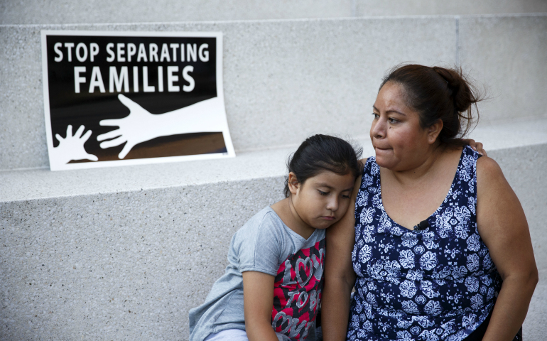 An immigrant mother and daughter are seen in Los Angeles June 23. (CNS photo/Eugene Garcia, EPA)