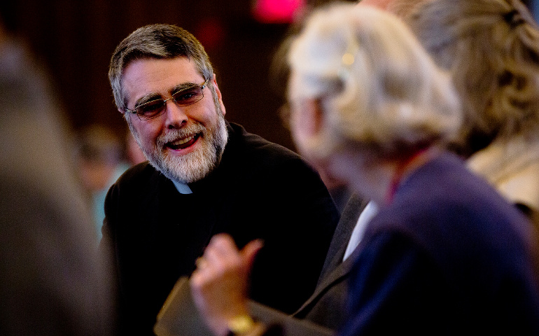 U.S. Chaldean Bishop Francis Kalabat chats with an audience member prior to the start of a a panel discussion about the survival of Christianity in the Middle East at The Catholic University of American in Washington Nov. 17. (CNS/Tyler Orsburn)