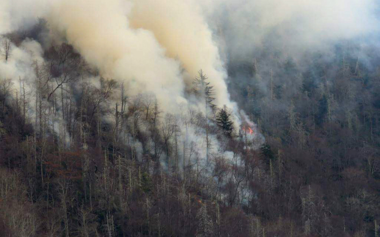 Smoke plumes from wildfires are seen Nov. 29 along the Smoky Mountains National Park near Gatlinburg, Tenn. Raging wildfires fueled by high winds claimed the lives of at least three people, forced the evacuation of thousands, including Father Antony Punnackal of St. Mary's Church, and damaged hundreds of buildings in the popular mountain resort town. (CNS photo/courtesy National Park Services handout via Reuters)