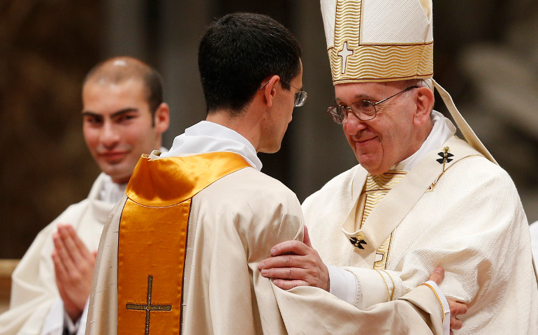 Pope Francis greets a new priest during the ordination Mass of 11 priests in St. Peter's Basilica at the Vatican April 17. (CNS / Paul Haring)