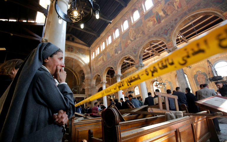 A nun cries as she stands inside St. Mark's Coptic Orthodox Cathedral Dec. 11 after an explosion inside the cathedral complex in Cairo. A bomb ripped through the complex, killing at least 25 people and wounding dozens, mostly women and children. (CNS photo/Amr Abdallah Dalsh, Reuters)