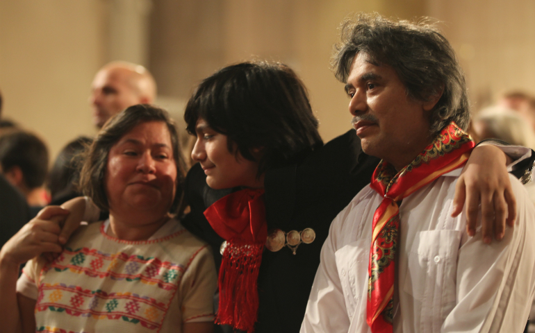 Samuel Catalan, middle, holds on to his mother, Alejandra Catalan, and father, Francisco Catalan, at a Dec. 10 Mass for the feast of Our Lady of Guadalupe at the Basilica of the National Shrine of the Immaculate Conception in Washington. Washington Auxiliary Bishop Mario E. Dorsonville told the largely immigrant crowd that the Catholic Church stands with them in "these difficult moments" of uncertainty about immigration matters in the country. (CNS photo/Rhina Guidos)