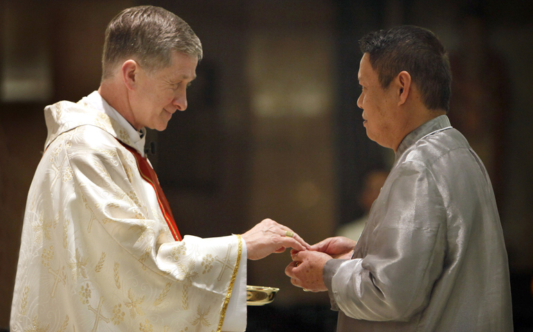 Then-Archbishop Blase J. Cupich of Chicago distributes Communion during the Simbang Gabi Mass at Our Lady of Mercy Parish in this 2014 file photo. (CNS/Karen Callaway, Catholic New World)