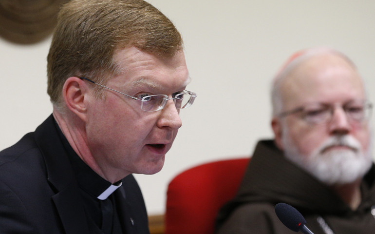 Jesuit Fr. Hans Zollner speaks in early February 2016 at the Pontifical Gregorian University in Rome during a news conference. At right is Cardinal Sean O'Malley of Boston. (CNS/Paul Haring)