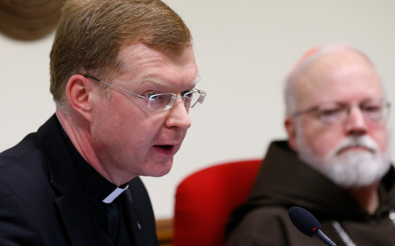 Jesuit Fr. Hans Zollner, president of the Center for Child Protection, speaks in early February 2016 at the Pontifical Gregorian University in Rome during a news conference officially launching the Center for Child Protection in Rome. At right is Cardinal Sean O'Malley of Boston, who heads the Pontifical Commission for Child Protection. (CNS/Paul Haring)