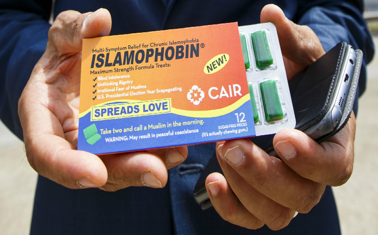 A man near the Republican National Convention in Cleveland in July holds a pack of chewing gum called '"Islamophobin." The packaging attempts to bring attention to the issue of anti-Muslim attitudes in the United States. (CNS photo/Justin Lane, EPA)