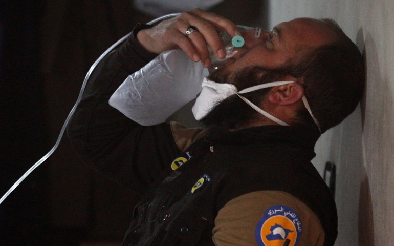 A civil defence member breathes through an oxygen mask, after what rescue workers described as a suspected gas attack in the town of Khan Sheikhoun in rebel-held Idlib, Syria April 4. (REUTERS/Ammar Abdullah)