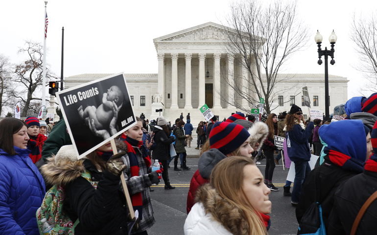Pro-life advocates walk past the Supreme Court building during the March for Life in Washington Jan. 22, 2016. (CNS/Gregory A. Shemitz) 