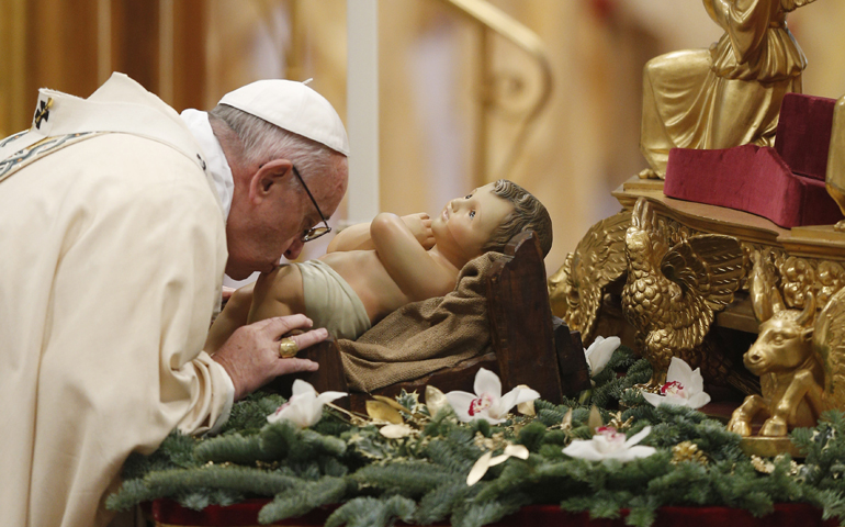 Pope Francis kisses a figurine of the baby Jesus as the start of a Mass marking the feast of the Epiphany Jan. 6 in St. Peter's Basilica at the Vatican. (CNS/Paul Haring)