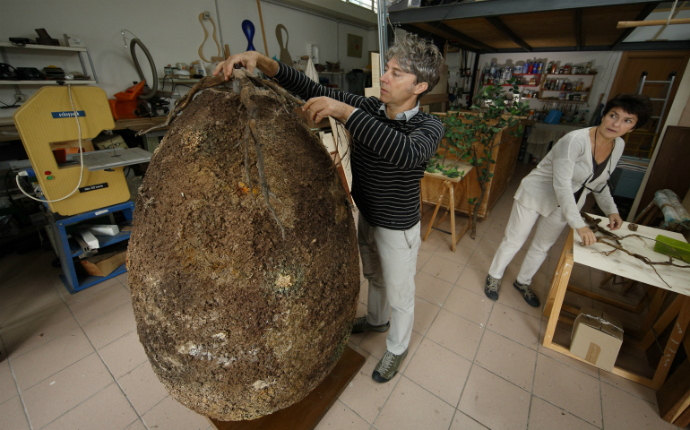 Raoul Bretzel and Anna Citelli set up a sample biodegradable burial pod developed by their company, Capsula Mundi, at their design studio in Rome Oct. 11. Recent Vatican guidelines on cremation and burial address the growing trend of "green burials." (CNS photo/Paul Haring)