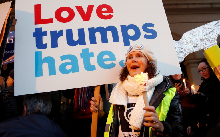 A woman holds a sign and a candle as she takes part in the women's rights demonstration "Lights for Rights" to protest Donald Trump's inauguration as the 45th president of the United States at the U.S. Capitol in Washington. (CNS/Reuters/Francois Lenoir) 