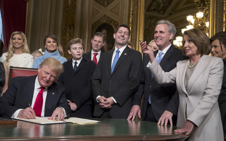President Donald Trump, joined by congressional leadership and his family as he formally signs his Cabinet nominations into law Jan. 20 in Washington. (CNS/J. Scott Applewhite, pool via Reuters)