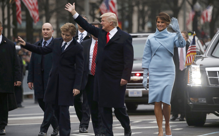 U.S. President Donald Trump and first lady Melania Trump wave as they walk with their son, Barron, along Pennsylvania Avenue during the Jan. 20 inaugural parade from the U.S. Capitol in Washington. (CNS/Jonathan Ernst, Reuters)