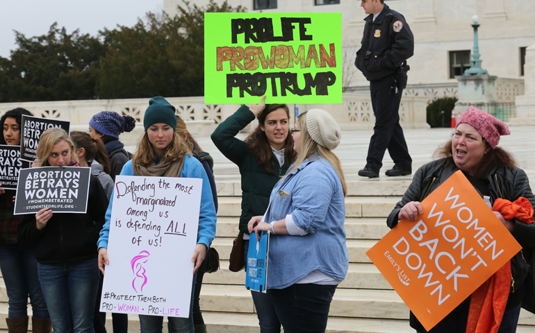 Pro-life supporters gather outside the U.S. Supreme Court next to a participant in the Women's March on Washington Jan. 21. (CNS/Bob Roller)