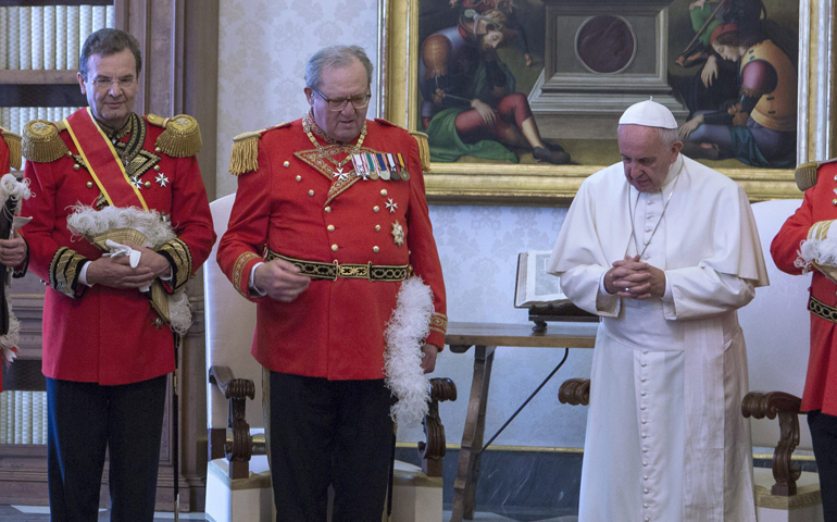 Pope Francis prays with Albrecht Freiherr von Boeselager, left, then-grand chancellor of the Sovereign Military Order of Malta, and Fra Matthew Festing, grand master of the order, during a private audience at the Vatican in this June 23, 2016, file photo. (CNS/Maria Grazia Picciarella, pool)