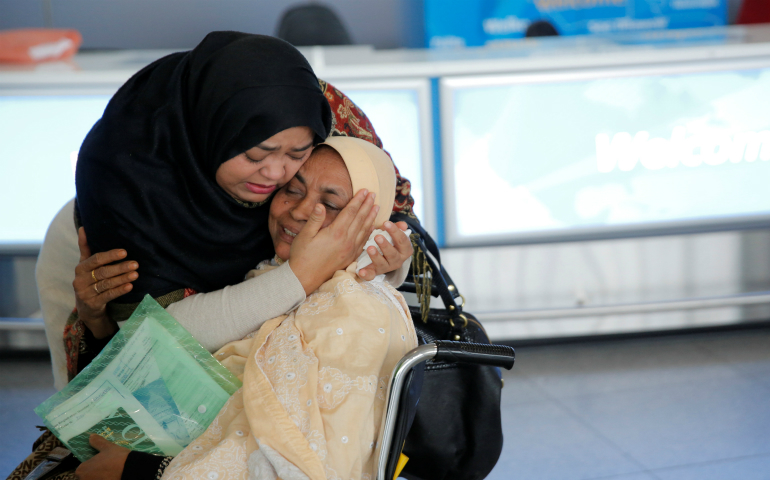 A woman greets her mother after she arrived from Dubai at John F. Kennedy International Airport in New York City Jan. 28. (CNS photo/Andrew Kelly, Reuters)
