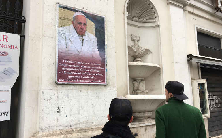 A poster expressing criticism of Pope Francis is seen in Rome Feb. 5. Several copies of the poster were placed in the center of Rome; some were quickly covered by city authorities. See story link below. (CNS/Paul Haring)
