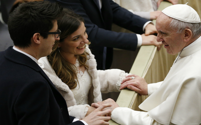 Pope Francis greets newlyweds Marco and Stefania Damiani of Rome during his general audience in Paul VI hall at the Vatican Feb. 8. Each week dozens of newlyweds from around the world meet the pope and receive a special papal blessing at the general audience. (CNS photo/Paul Haring)